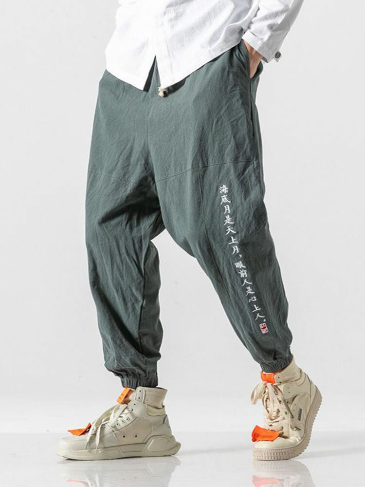 Detalle de costura con estampado de caracteres chinos para hombre 100% algodón Pantalones