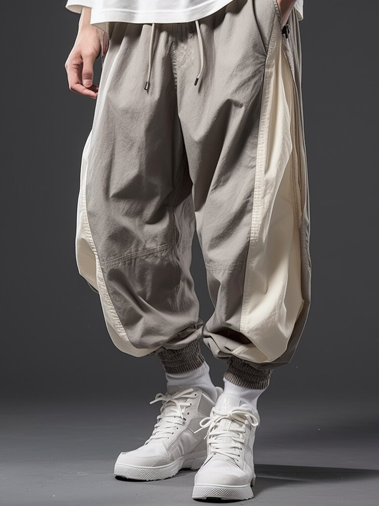 Cintura holgada con cordón elástico y puños elásticos de retazos de bloques de color para hombre Pantalones