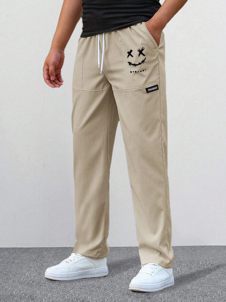 Bolsillos laterales con estampado de sonrisa para hombre Cintura con cordón Pantalones