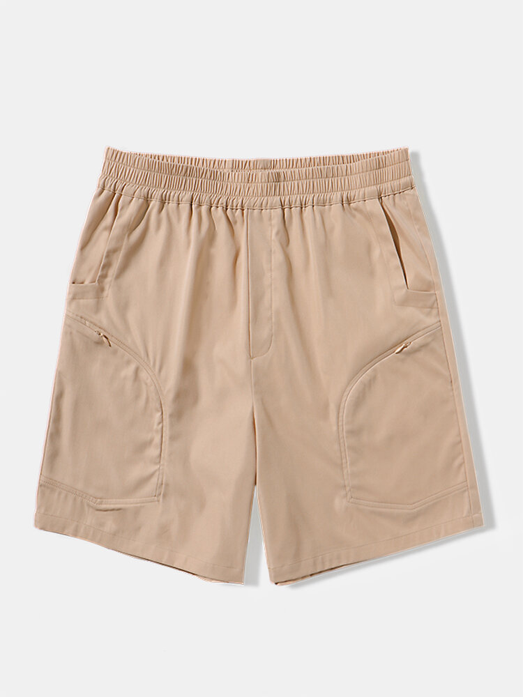 Pantalones cortos casuales de cintura elástica con bolsillo con cremallera de color sólido para hombre