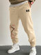 Pantalones deportivos holgados con cordón en la cintura con estampado de flores de cerezo japonés para hombre - Caqui