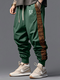 पुरुषों के लिए स्माइल एथनिक जियोमेट्रिक प्रिंट पैचवर्क लूज ड्रॉस्ट्रिंग कमर पैंट - हरा
