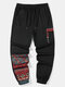 मेन्स एथनिक जियोमेट्रिक प्रिंट पैचवर्क लूज ड्रॉस्ट्रिंग स्वेटपैंट - काली