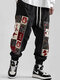 पुरुषों की विंटेज फ्लोरल प्रिंट पैचवर्क लूज़ ड्रॉस्ट्रिंग कमर पैंट - काली