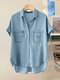 Blusa de solapa de manga corta con botones en el frente y bolsillo alto bajo de mezclilla - azul