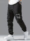 पुरुषों की स्माइल फेस प्रिंट मल्टी पॉकेट ड्रॉस्ट्रिंग कमर कार्गो पैंट - काली