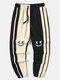 Pantaloni sportivi da uomo con risvolto largo e patchwork a contrasto con stampa faccia sorridente - Albicocca