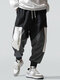 Pantalon décontracté à taille avec cordon de serrage pour homme avec slogan imprimé et bloc de couleurs - Noir